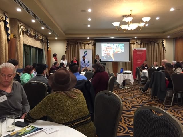 Guests seated at round tables during the Community Leadership Program graduation gathering.