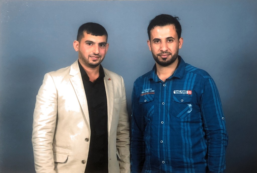 Hussam Saraf with a fellow attendee in a graduation-day portrait.