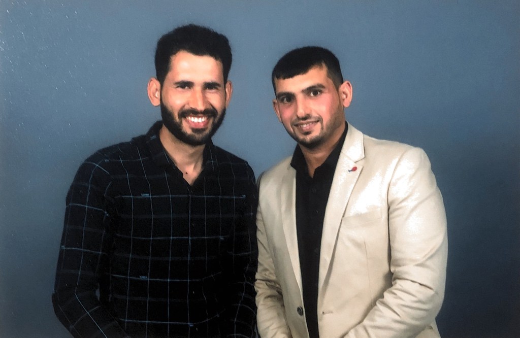 Hussam Saraf with another attendee in a portrait from the 2017 Community Leadership Program graduation.