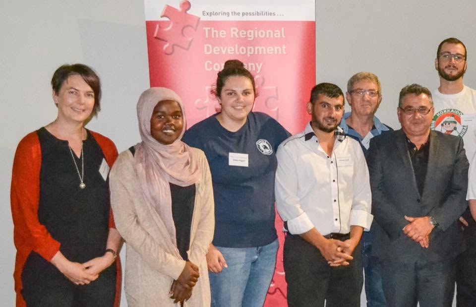 Hussam Saraf with fellow participants beside a Regional Development Company banner at the 2017 program launch.