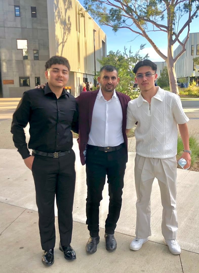 Three people standing together beside the school buildings. GSSC Class of 2025.