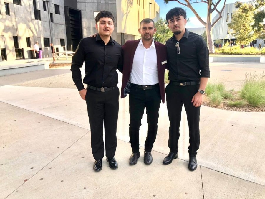 A wider portrait of three people on a campus walkway. GSSC Class of 2025.