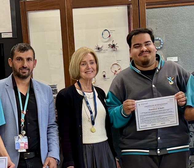Hammood with Hussam Saraf and the school principal at the 2026 Outstanding Multicultural Leadership & Community Service recognition presentation.