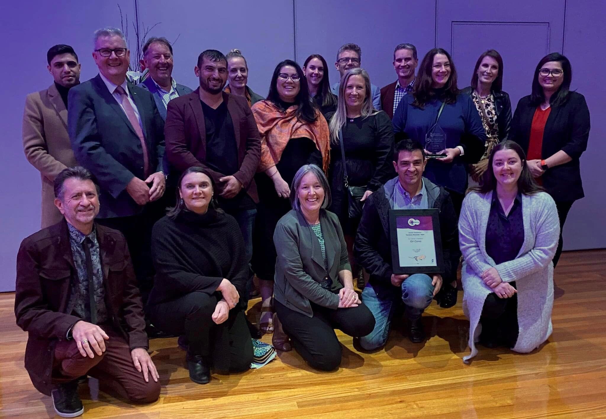 A group of GV Cares representatives and supporters with the team award certificate at the 2022 ceremony.