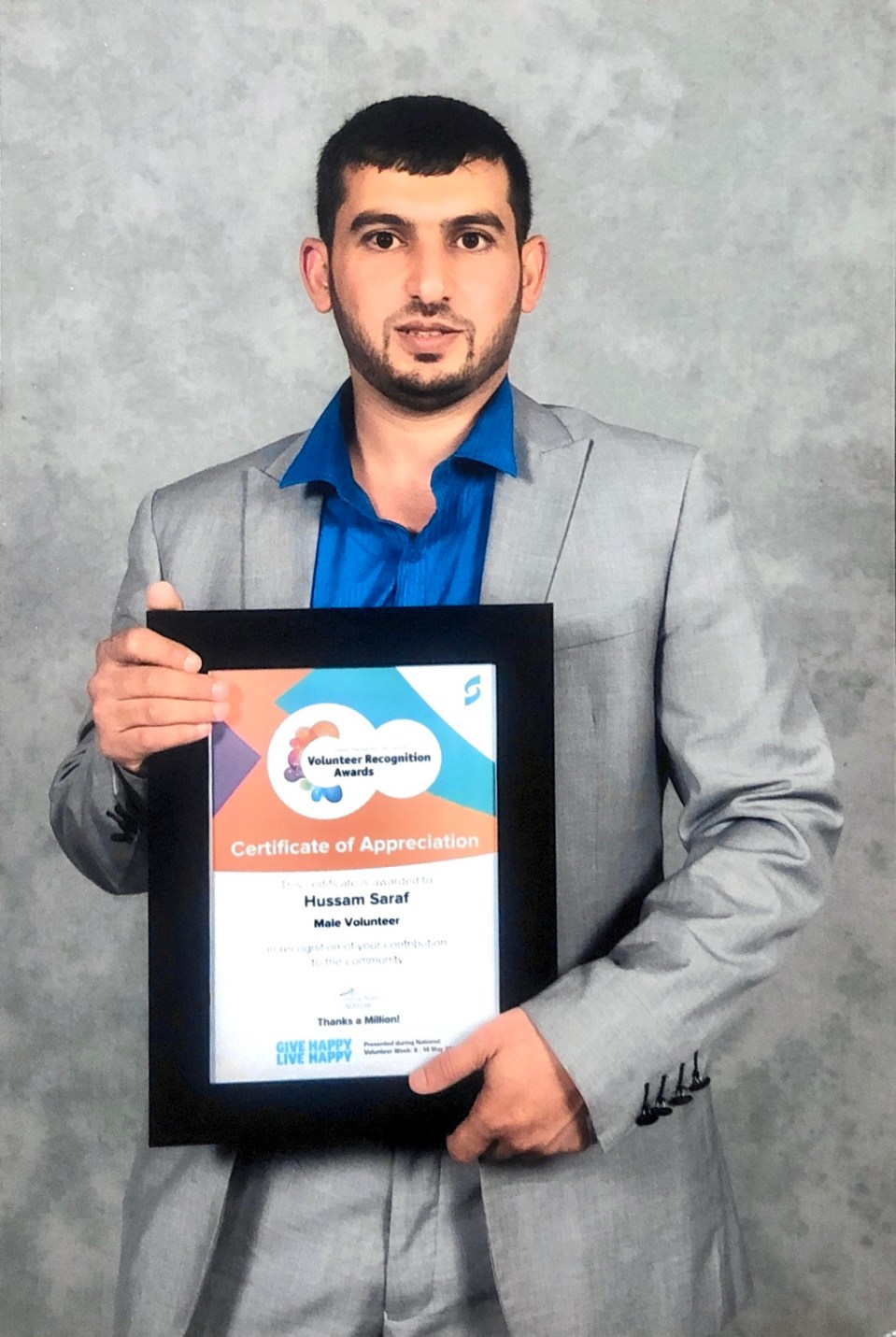 Hussam Saraf holding his Certificate of Appreciation in the Male Volunteer category of the 2017 Volunteer Recognition Awards.