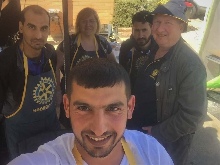A group photograph of volunteers wearing Rotary Mooroopna aprons.