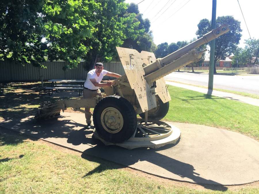 A visitor beside a historic artillery display in a public park, from the October 2017 photograph collection.