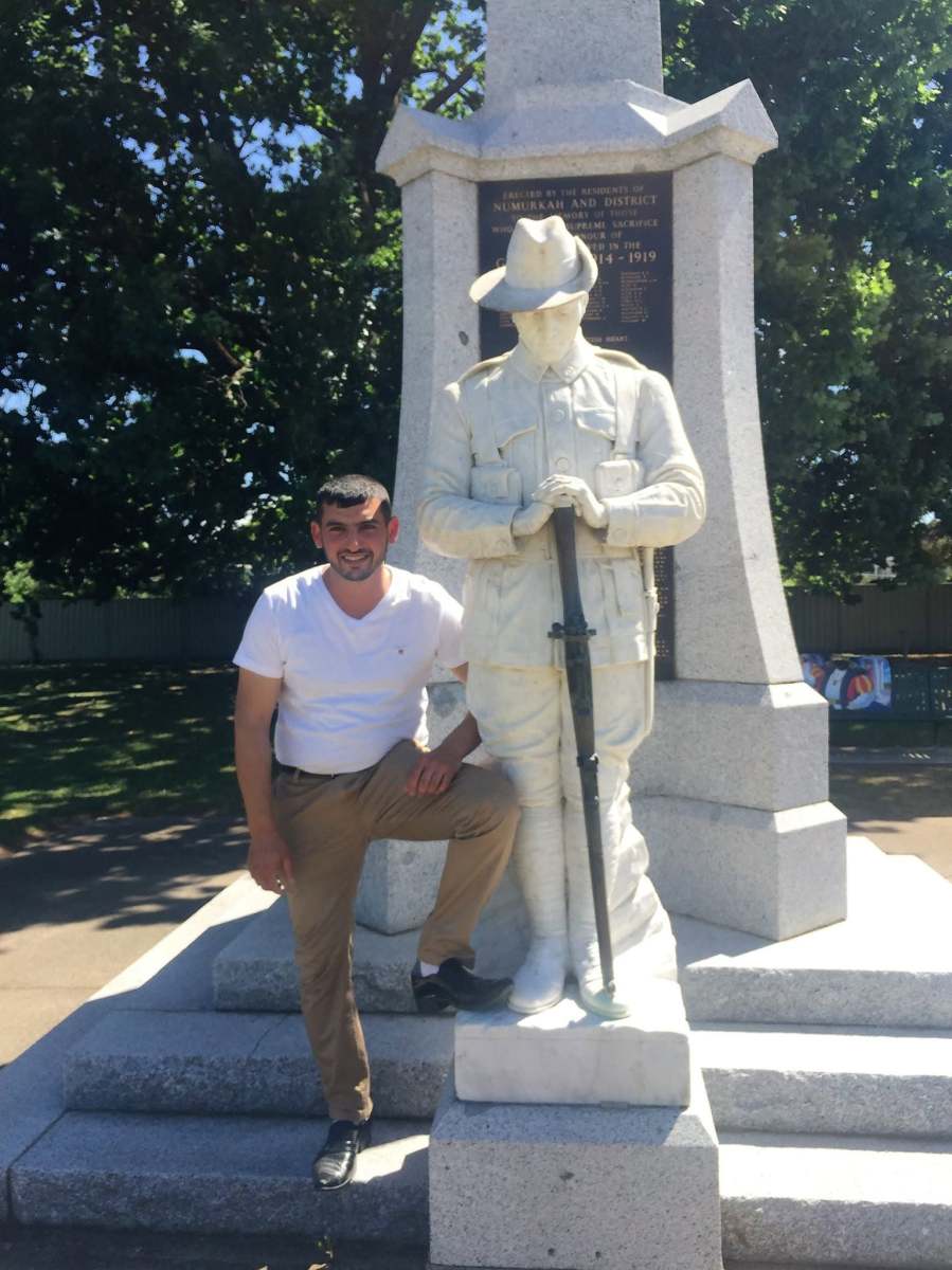 A visitor beside the soldier statue at the Numurkah and District war memorial.