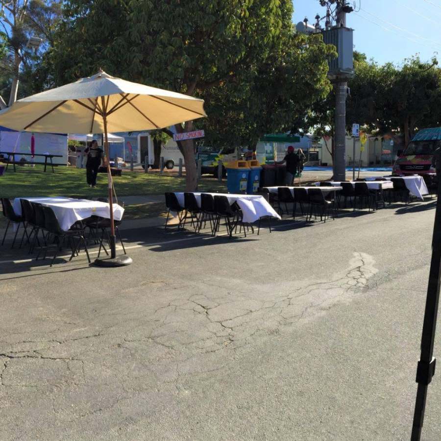 Outdoor tables, chairs and umbrellas arranged for the food festival.