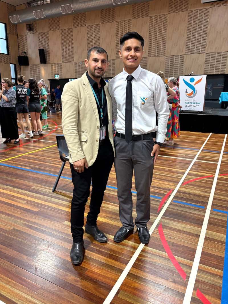 Hussam Saraf and Safa Zahir standing together in the GSSC hall at the 2025 Awards Night.