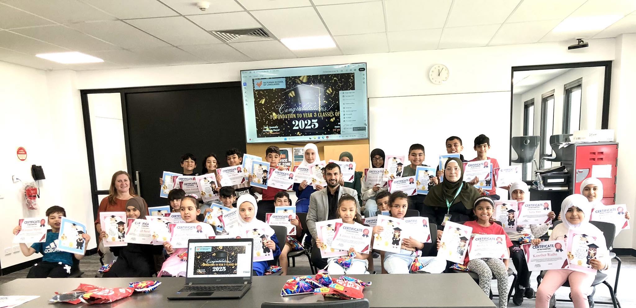 Hussam Saraf with VSL students and colleagues at a classroom certificate celebration in 2025.