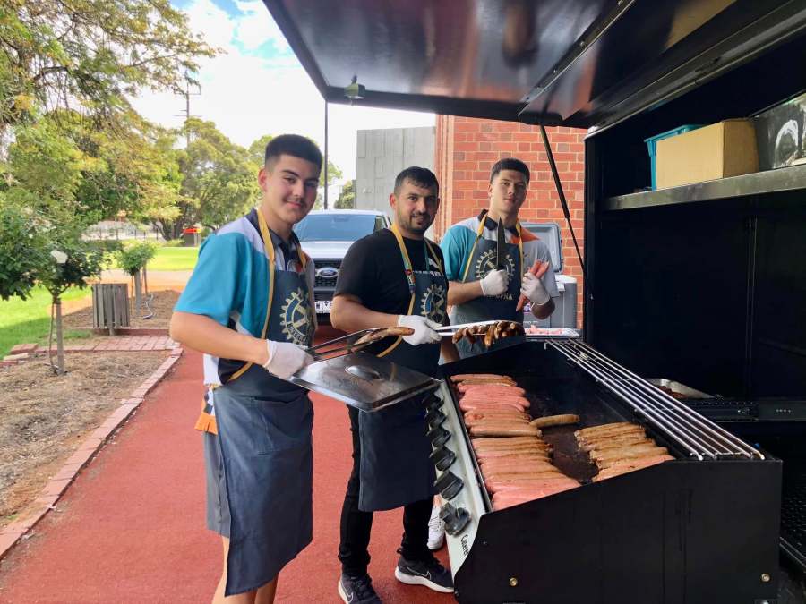 Kadir SUT, Hussam Saraf and another student helping at the Aspirations Day barbecue.