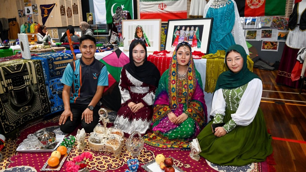 Safa Zahir, Fatima Chaman Ali, Muzhgan Qazikhil and Zahra Qurbani seated at the Afghan cultural stall at GSSC’s Cultural and Language Expo.