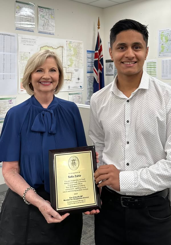 Safa Zahir with Kim O’Keeffe, holding a framed plaque recognising his youth leadership and community contribution.