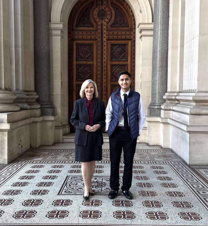 Safa Zahir with another attendee in a grand hallway during his Youth Parliament experience.