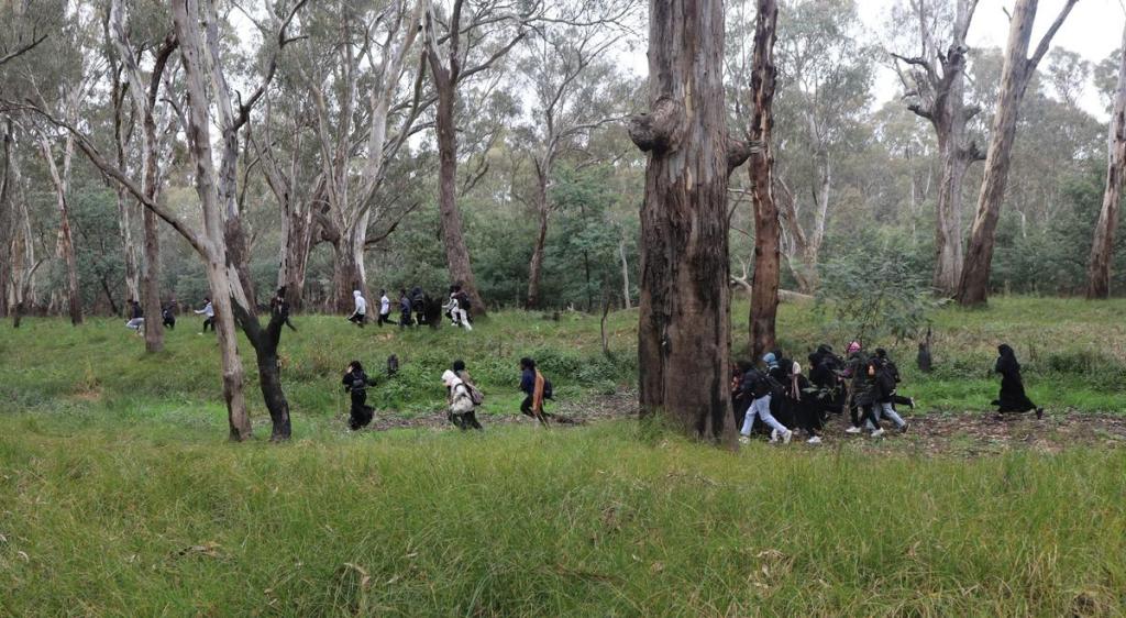 Film participants moving through a woodland setting during the making of The Way to Freedom.