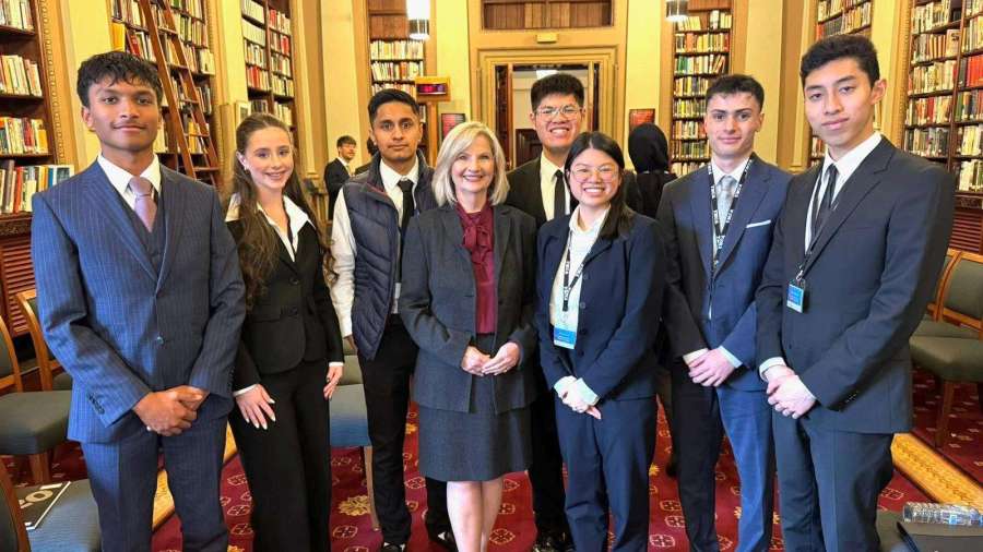 Kim O’Keeffe with youth parliamentarians in the parliamentary library, as pictured in the Youth Parliament report.