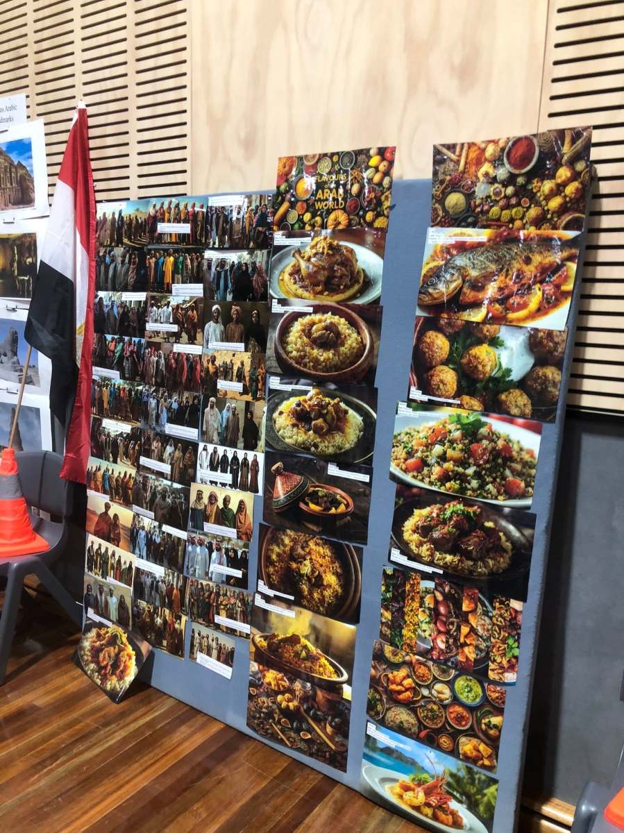 A vertical display of food and cultural heritage photographs at the Arabic station.