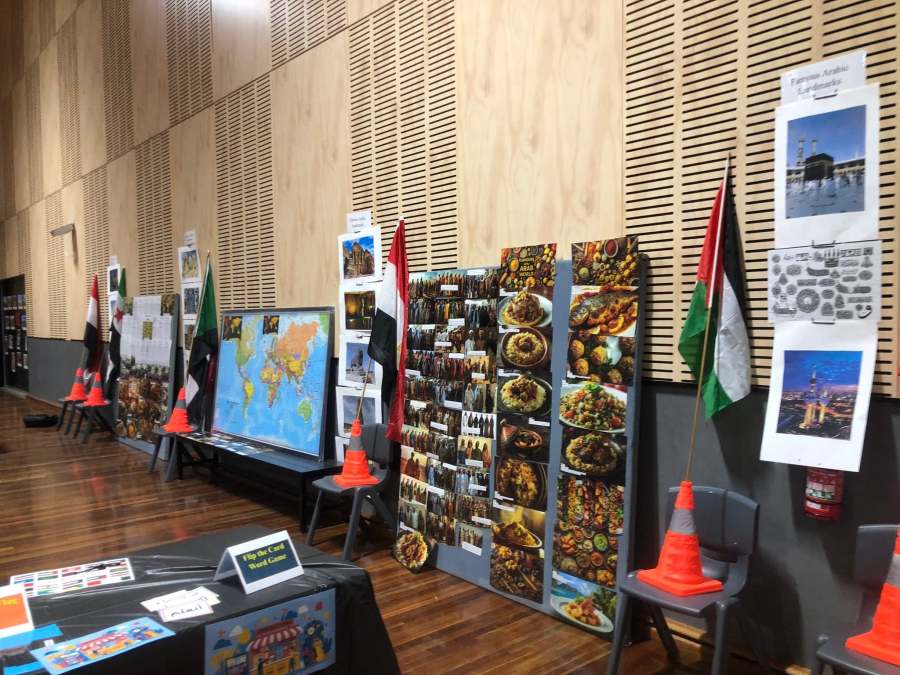 Arabic station display with a map, flags and a board of photographs.
