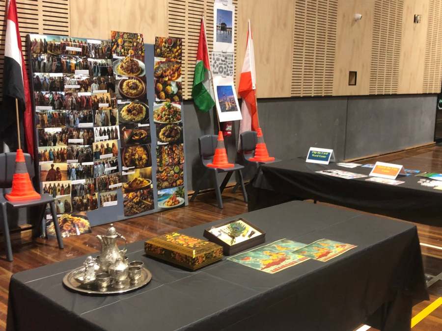 Books and cultural objects, including a tea tray, displayed at the Arabic station.