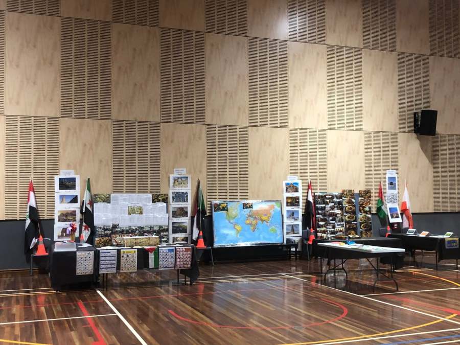 A wide view of the Arabic station and activity tables before visitors arrive.