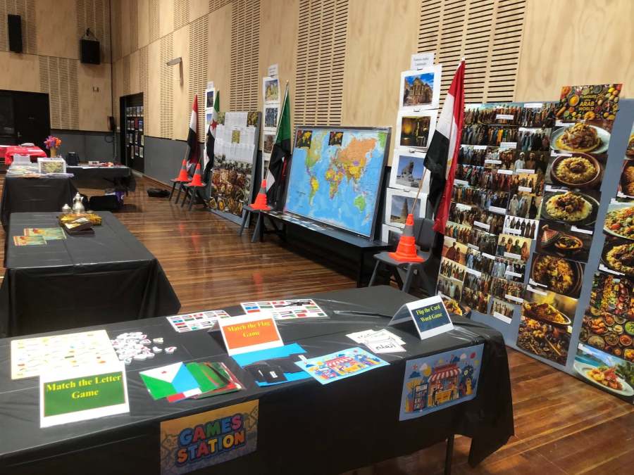 Arabic station display with learning tables and activity materials.