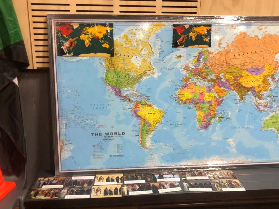 Close view of a world map and cultural photographs at the Arabic station.