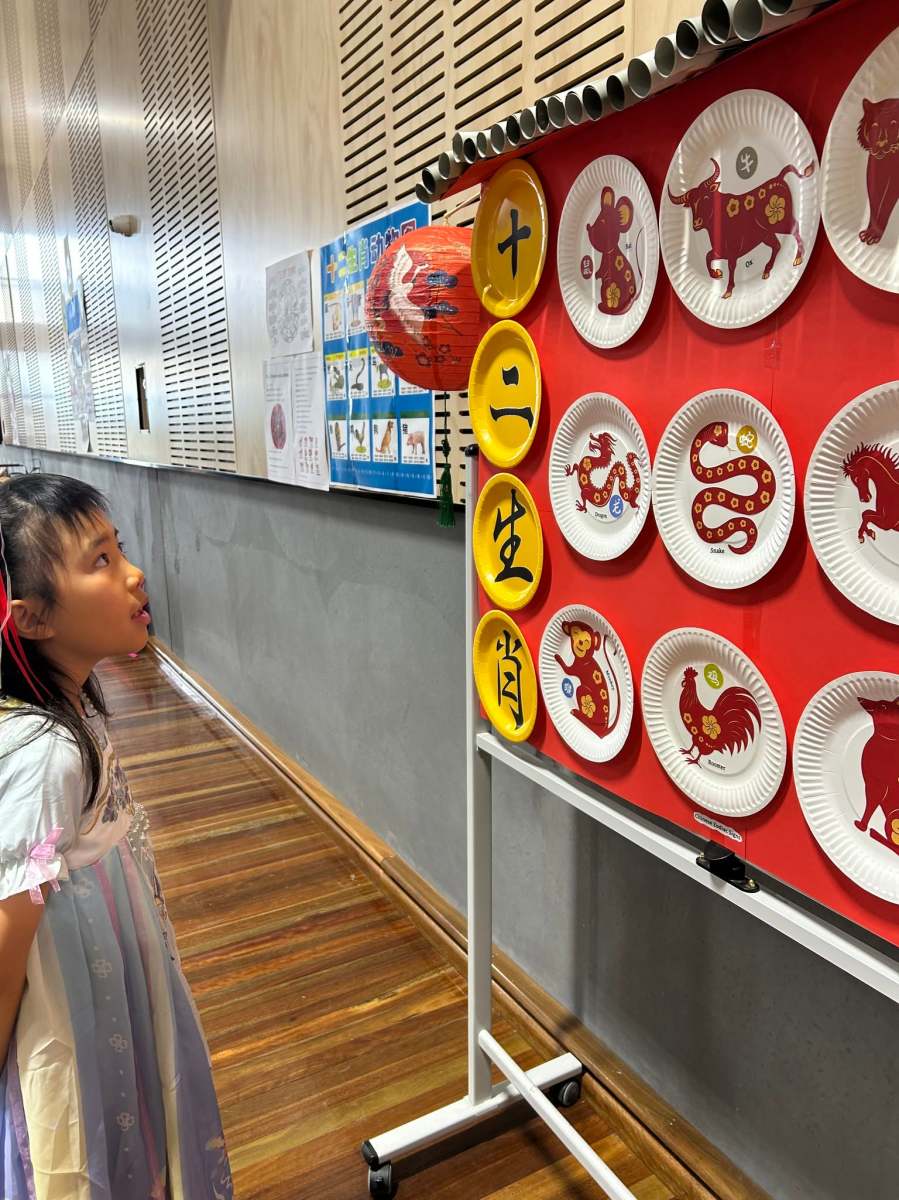 A young visitor exploring a language activity display at the Expo.