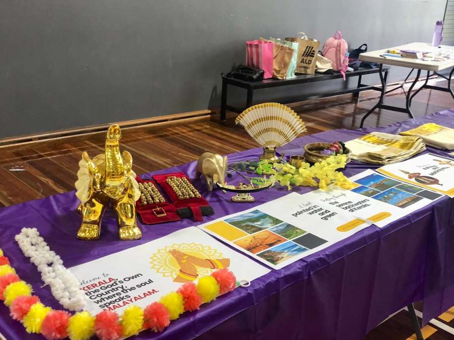 Decorative objects, printed information and colourful garlands arranged on a display table.