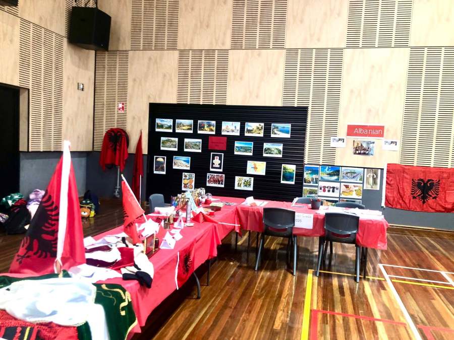 Photographs, flags and cultural materials displayed at a language station.