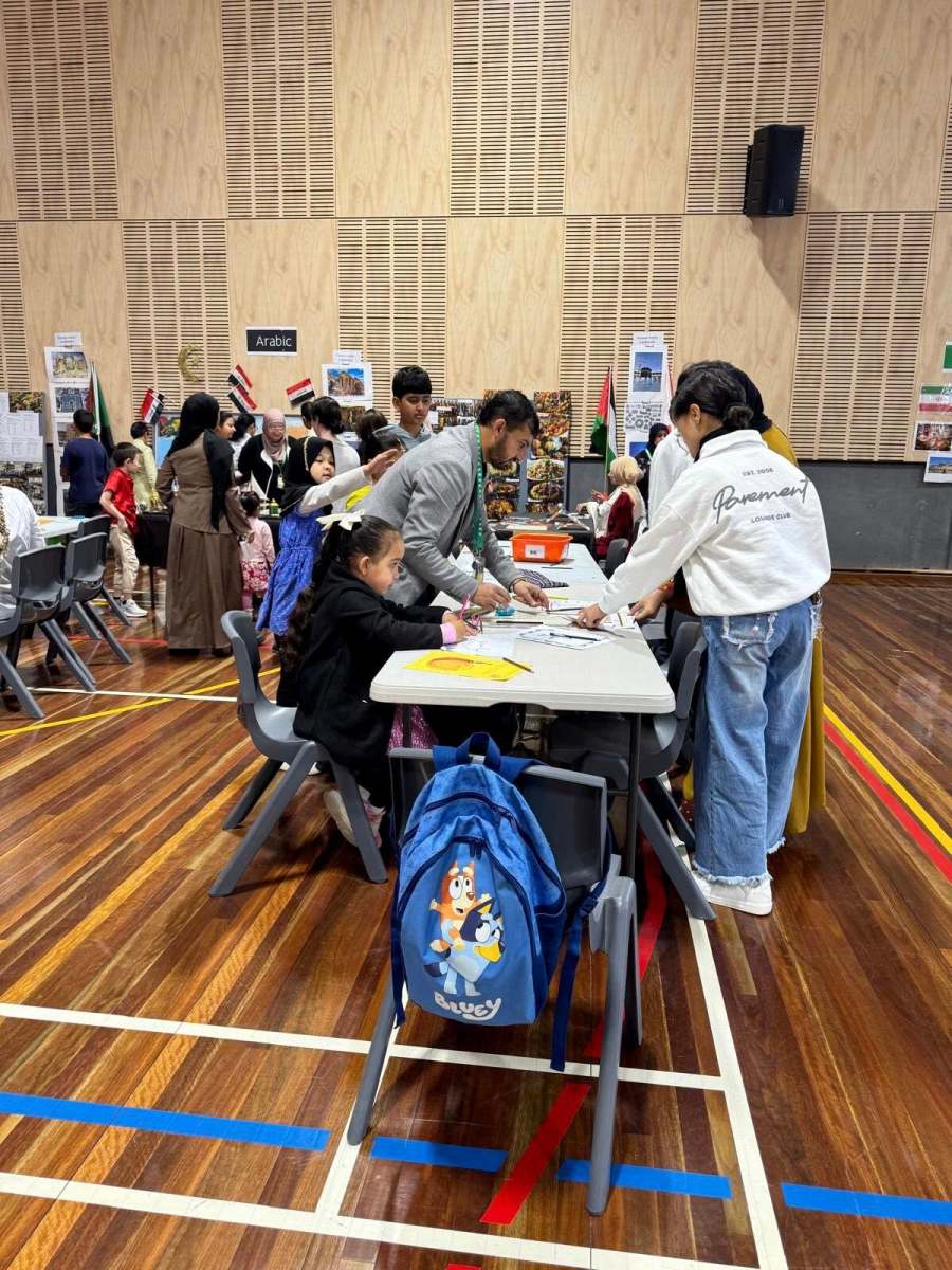 Visitors and educators taking part in activities around the display tables.