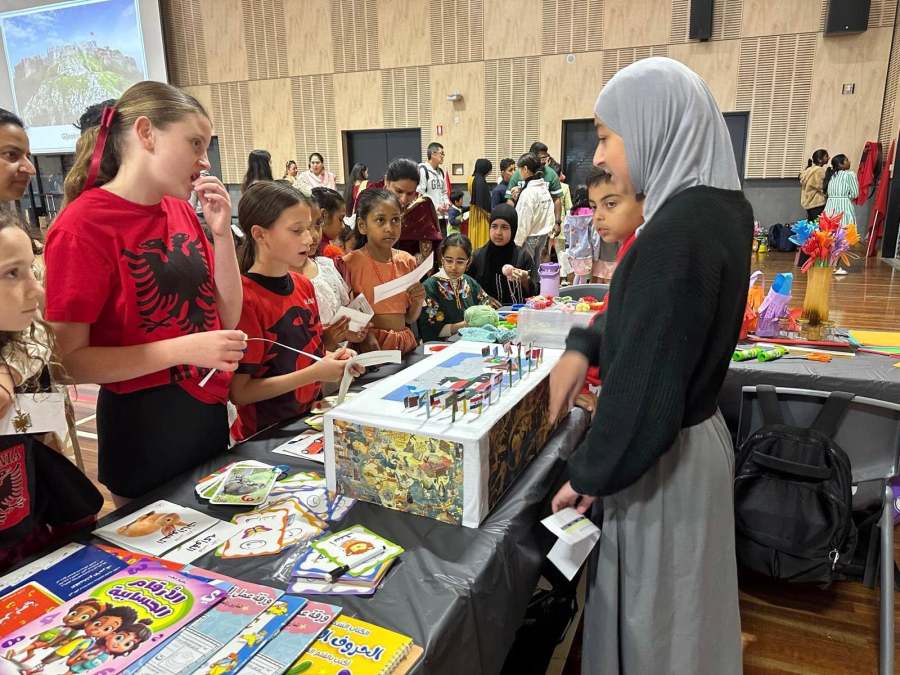 Students and educators gathered around the Arabic station activities.
