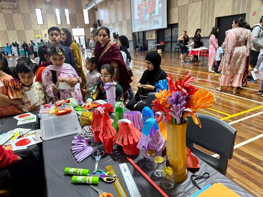 Young visitors exploring colourful craft materials at the Arabic station.