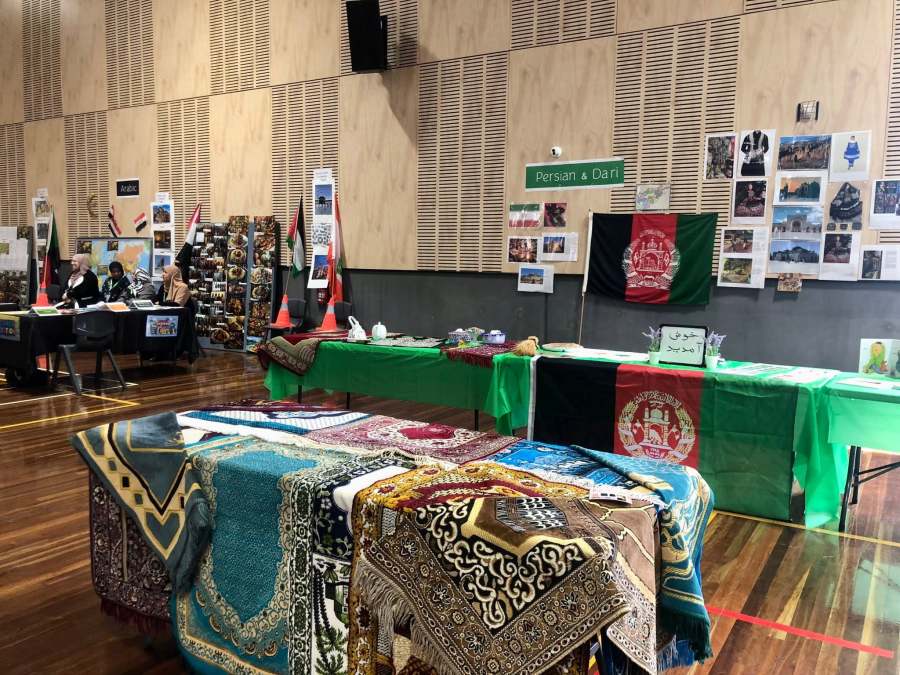 Several language stations displaying textiles, posters and cultural materials.